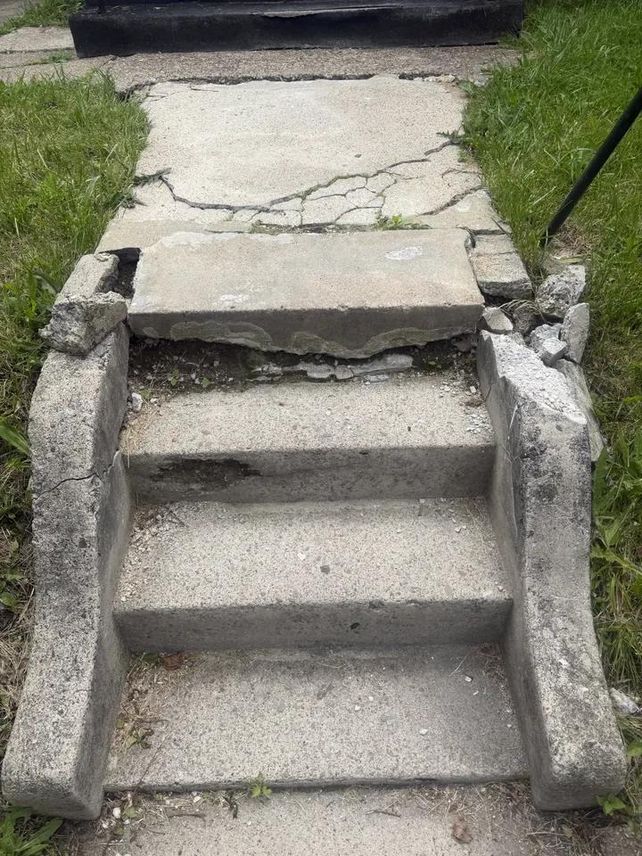 Cracked and worn concrete entry steps