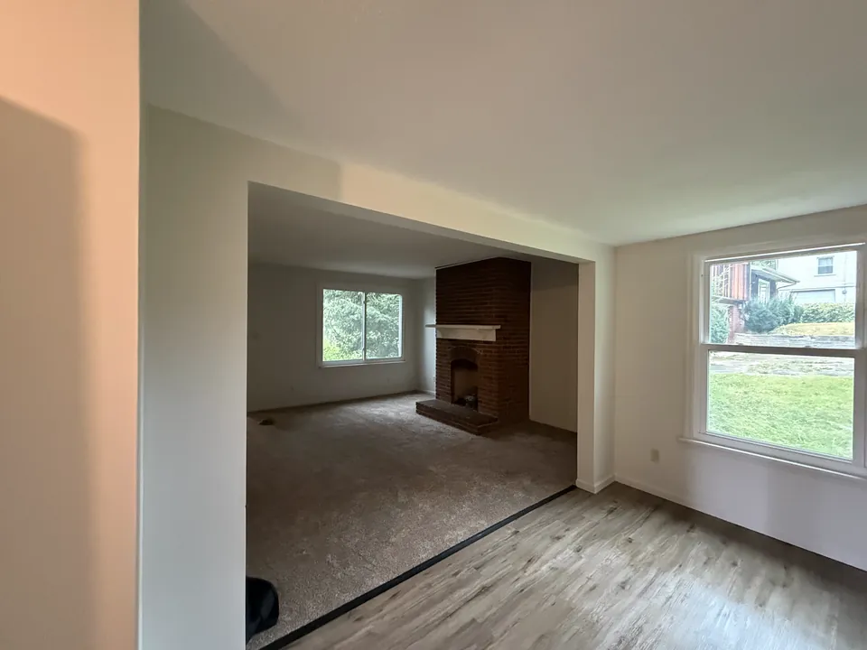 Renovated adjoining rooms with carpet, painted walls, and finished trim