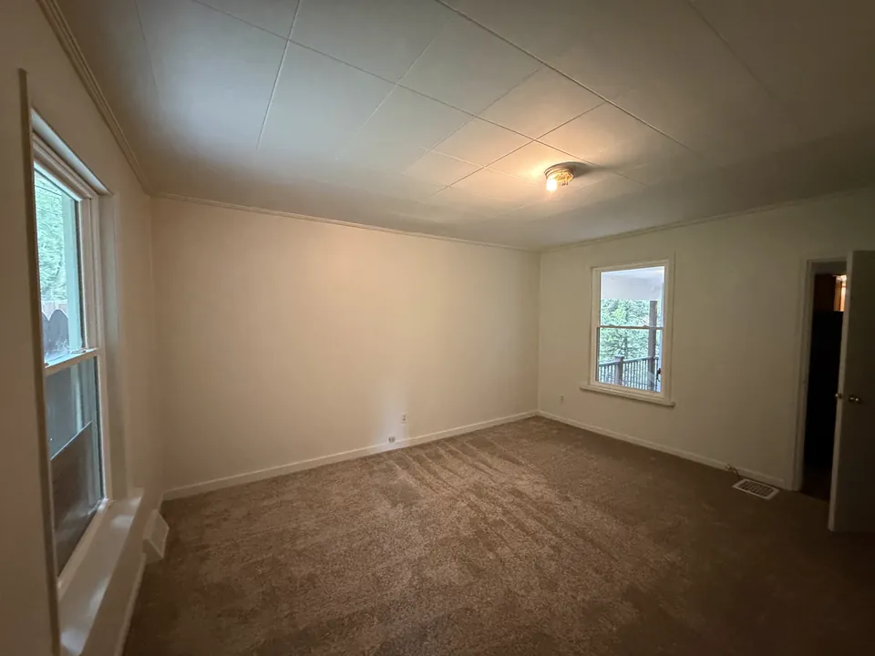 Installed carpet flooring with finished white baseboards